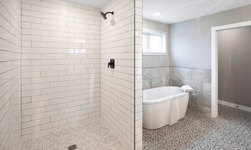 Tiled bathroom with standalone tub in master bathroom